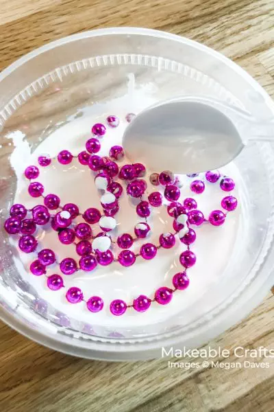 add your mardi gras beads to your paint and water mixture