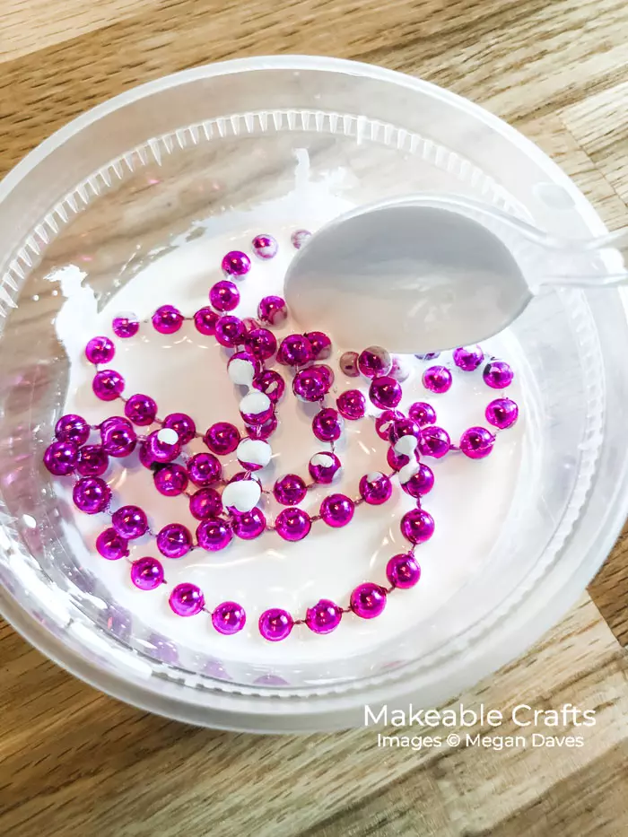 add your mardi gras beads to your paint and water mixture